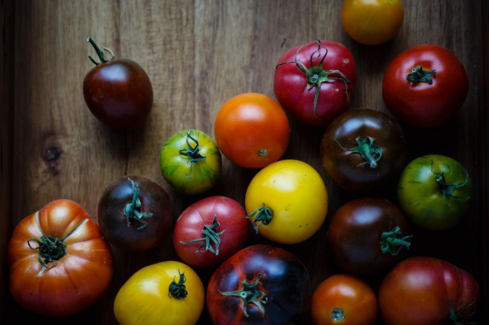 Free Image of Group of Tomatoes on Wooden Table 