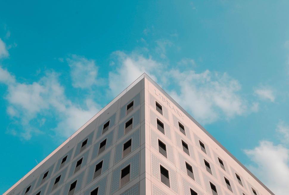 Free Image of Tall White Building Under Blue Sky 