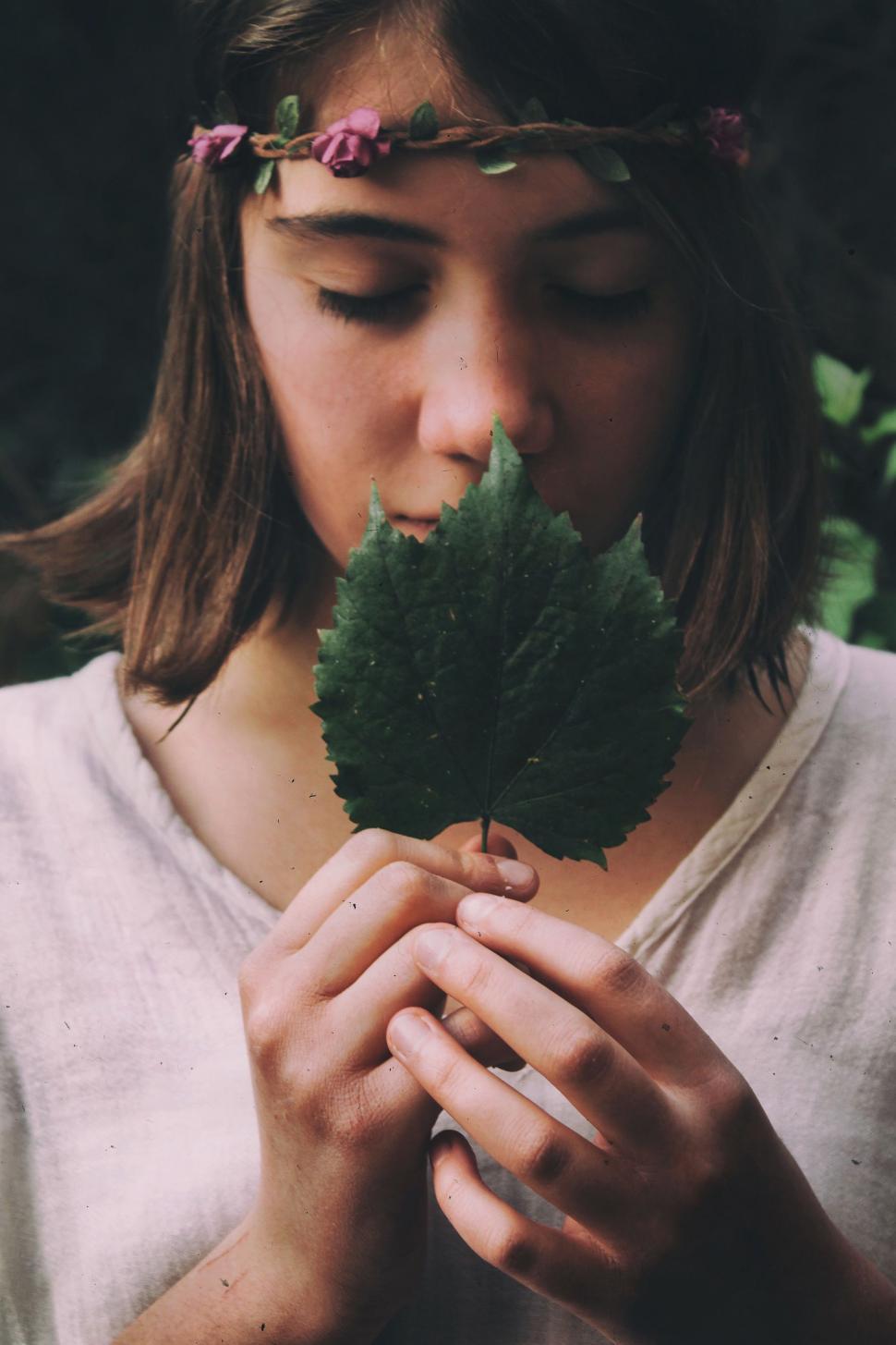 Free Image of Woman Holding a Leaf in Her Hands 