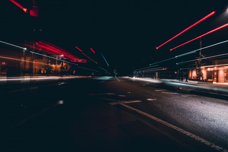 Free Image of Empty Street at Night With Red Lights 