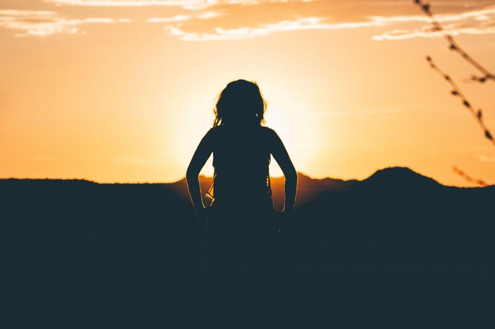 Free Image of Person Standing in Field at Sunset 