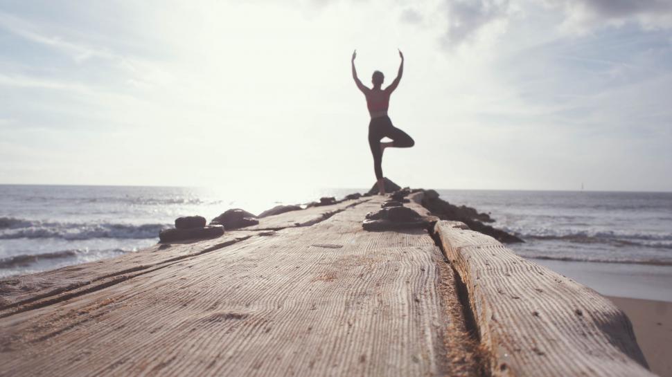 Free Image of Person Performing Yoga Pose on Beach 