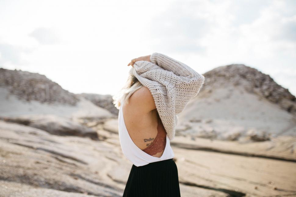 Free Image of Woman Wearing Scarf in Desert 