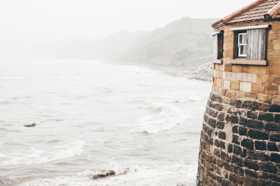 Free Image of Small House Perched on Cliff Overlooking Ocean 