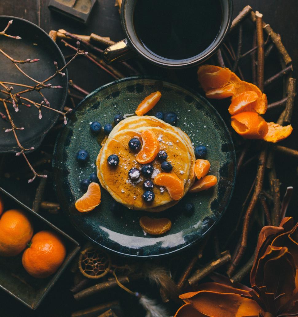 Free Image of Plate With Oranges and Blueberries Next to Coffee Cup 