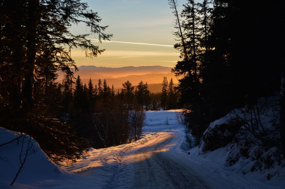 Free Image of Sun Setting on Snowy Road 