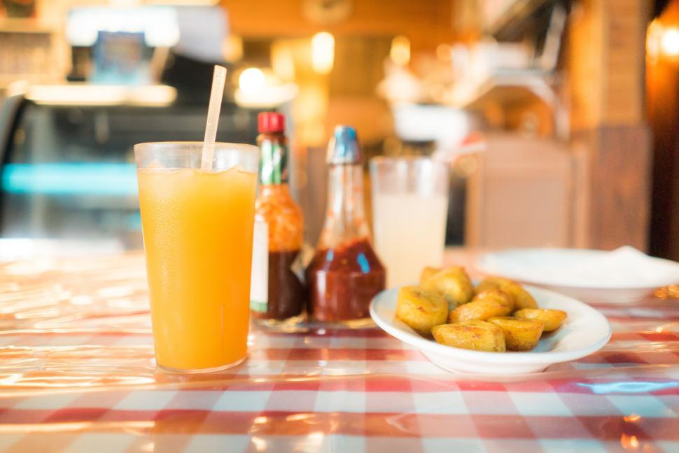 Free Image of Glass of Orange Juice Next to Plate of Food 