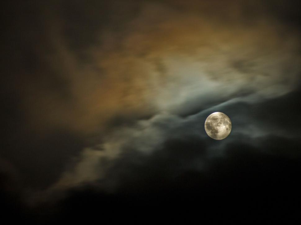 Free Image of Full Moon Seen Through Cloudy Sky 