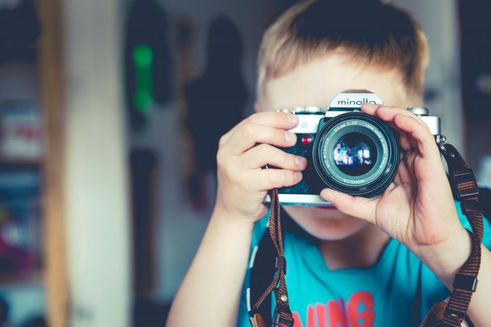 Free Image of Young Boy Capturing Moment With Camera 
