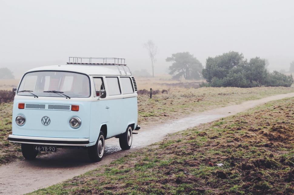 Free Image of VW Bus Driving Down Dirt Road 