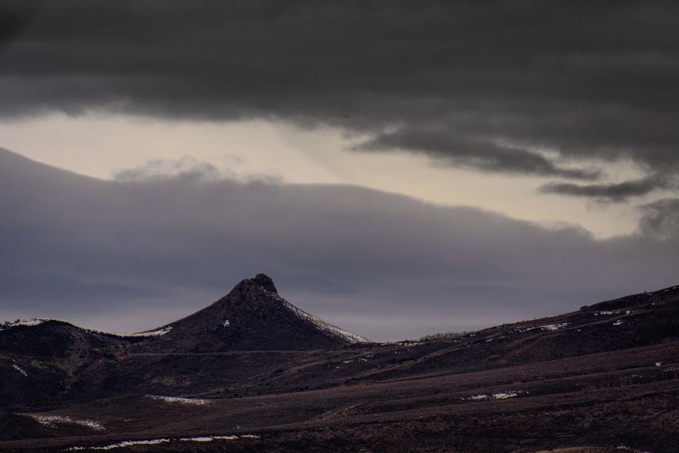 Free Image of Majestic Snow-Covered Mountain Beneath Overcast Sky 
