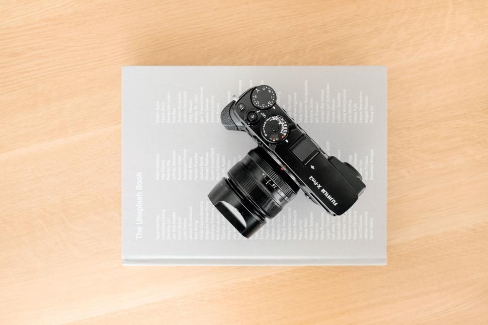 Free Image of Camera on Top of a Paper 