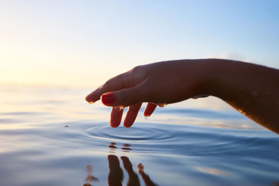 Free Image of Hand Reaching for Object in Water 