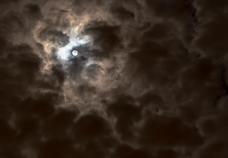 Free Image of Full Moon Peeking Through Clouds 