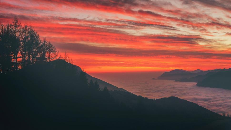 Free Image of Majestic Sunset Over Ocean and Mountains 