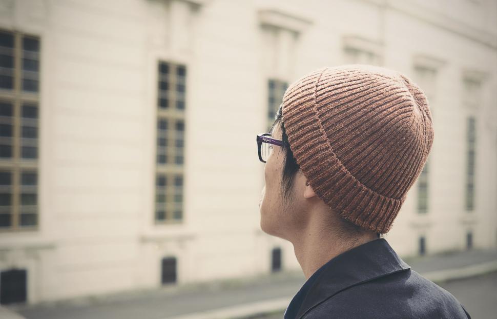 Free Image of Man in Beanie Looking Out Window 