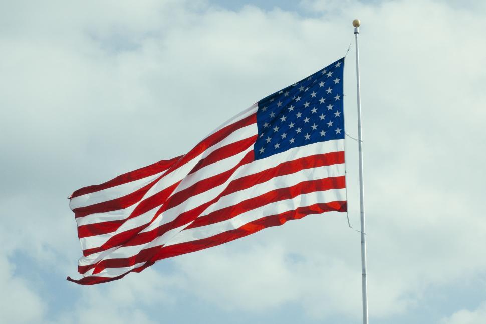 Free Image of Large American Flag Flying High in the Sky 