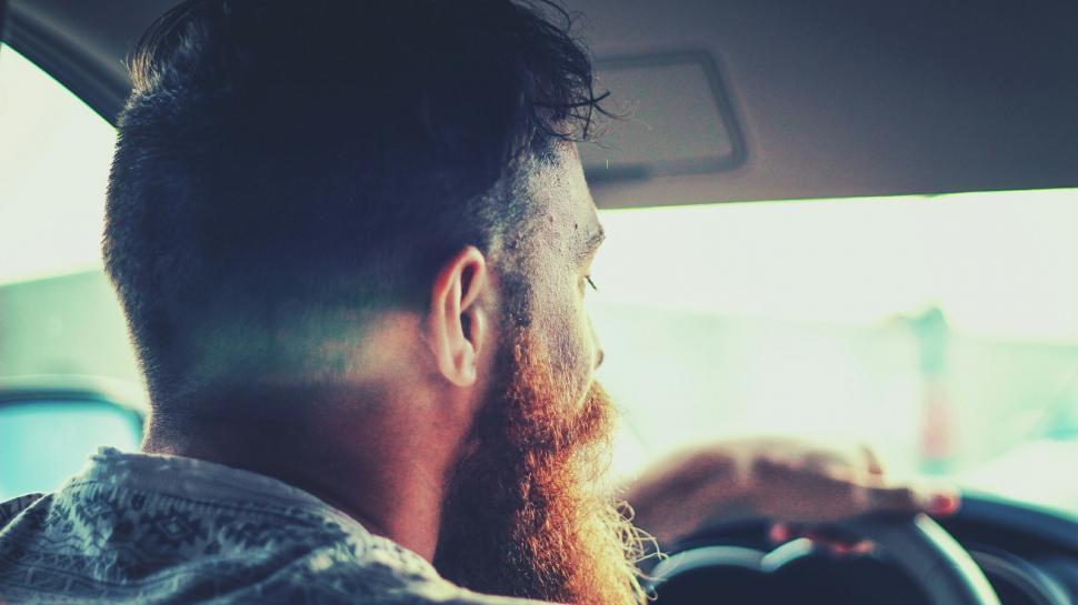 Free Image of Man With Long Beard Driving Car 