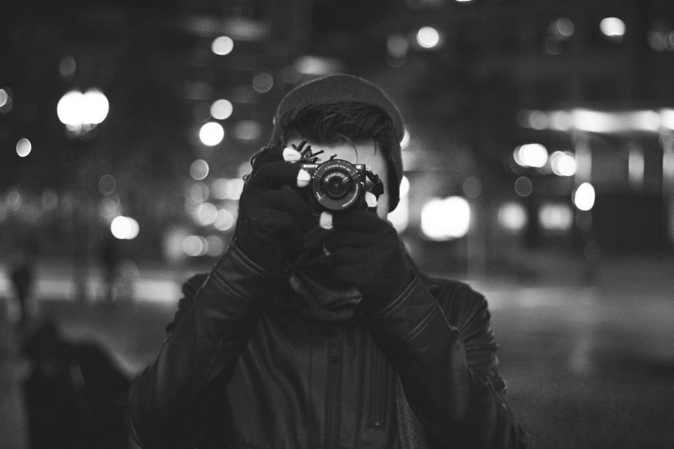 Free Image of Man Holding Camera Up to Face 