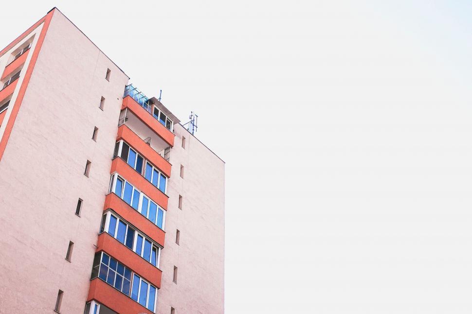 Free Image of Tall Red Building Against Sky Background 