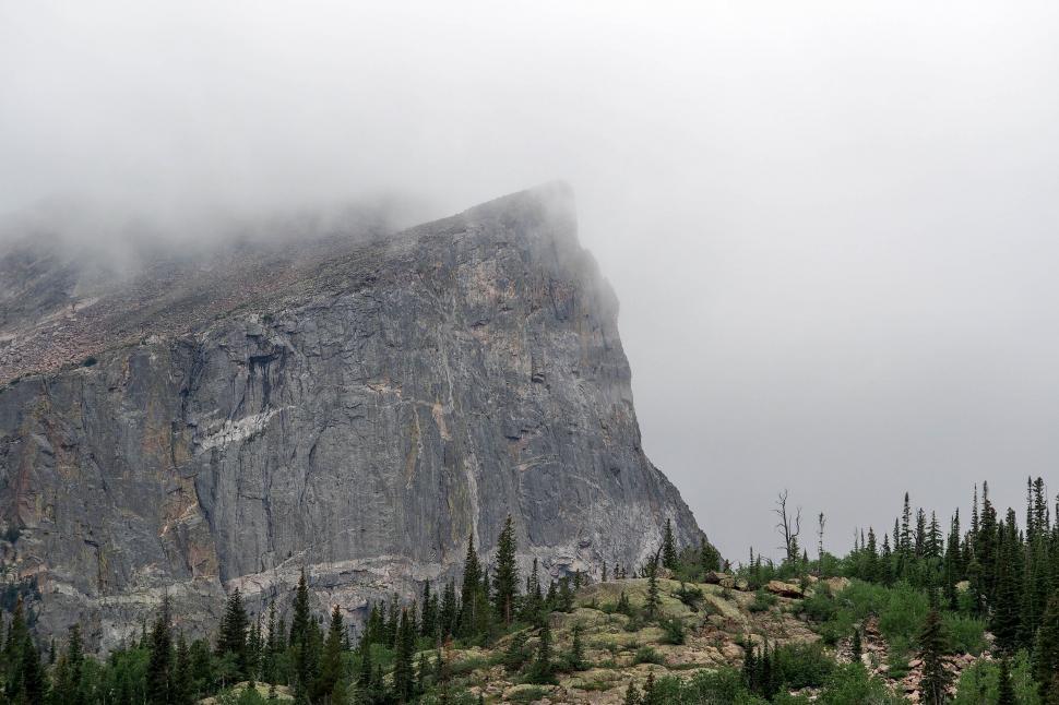 Free Image of Towering Mountain Enshrouded in Fog and Clouds 