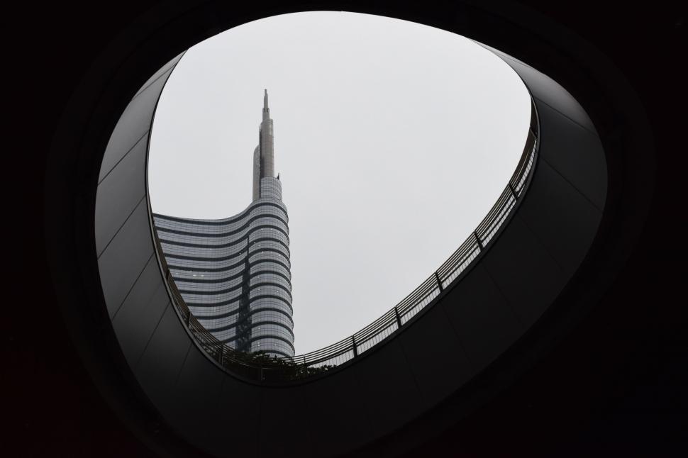 Free Image of View of Tall Building Through Circular Window 