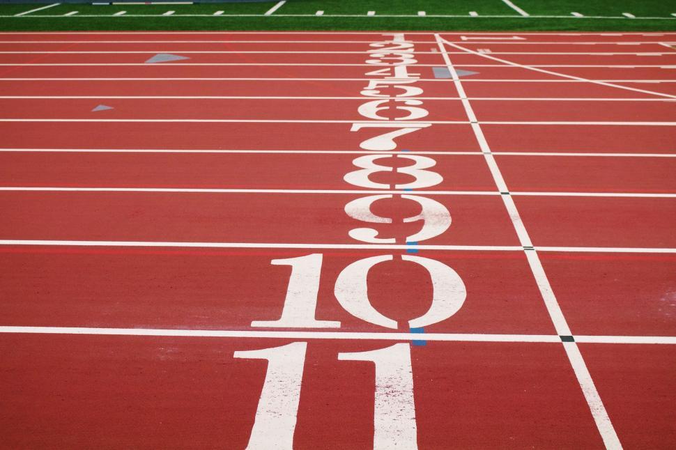 Free Image of Red Running Track With White Numbers 