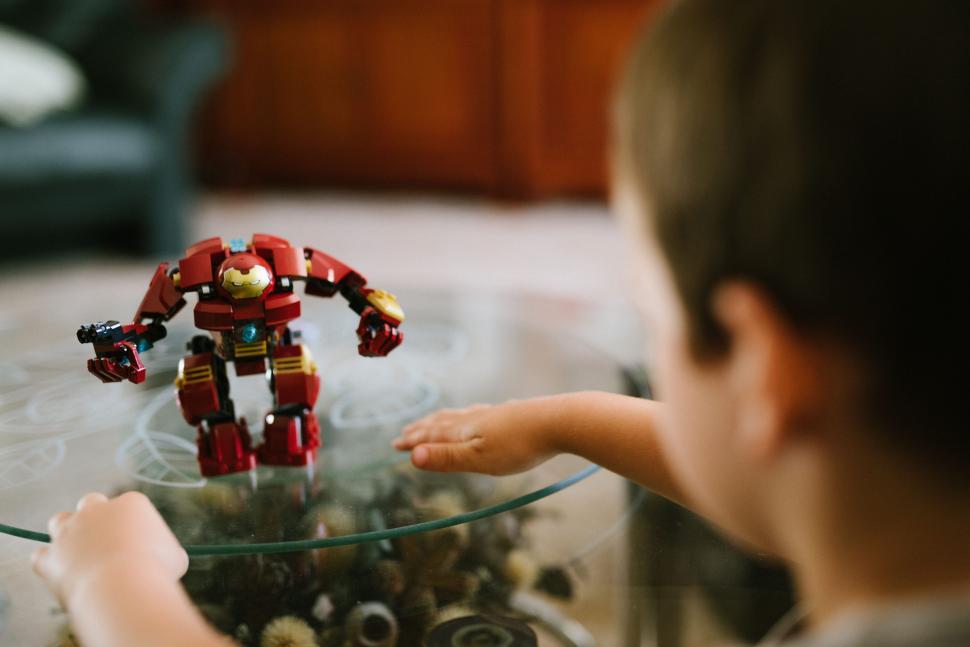 Free Image of Little Boy Playing With Robot Toy 