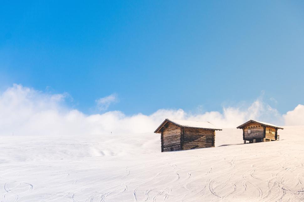 Free Image of Wooden Buildings on Snow Covered Slope 