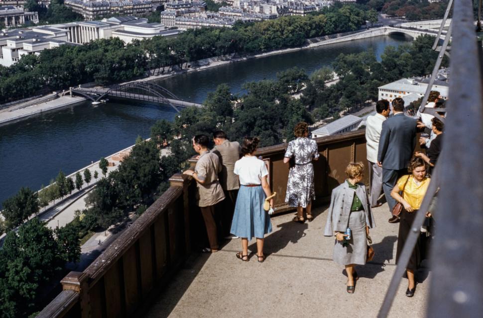 Free Image of Group of People Walking Down Walkway Next to River 