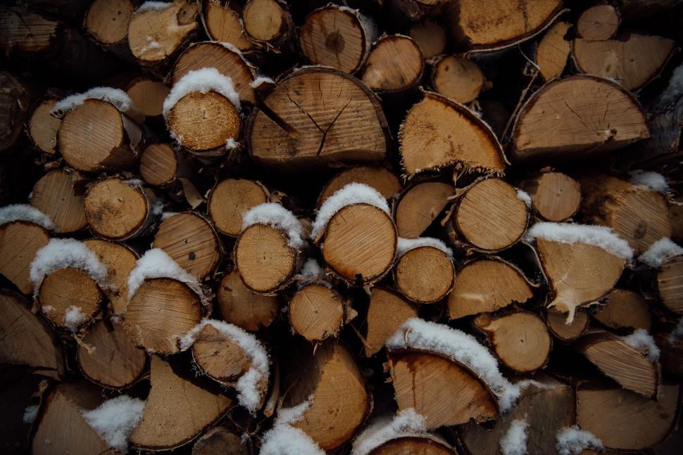 Free Image of Pile of Cut Logs Covered in Snow 