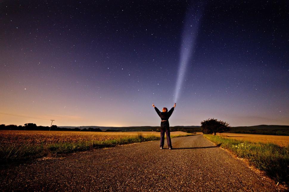 Free Image of Person Standing on Road With Arms Raised 
