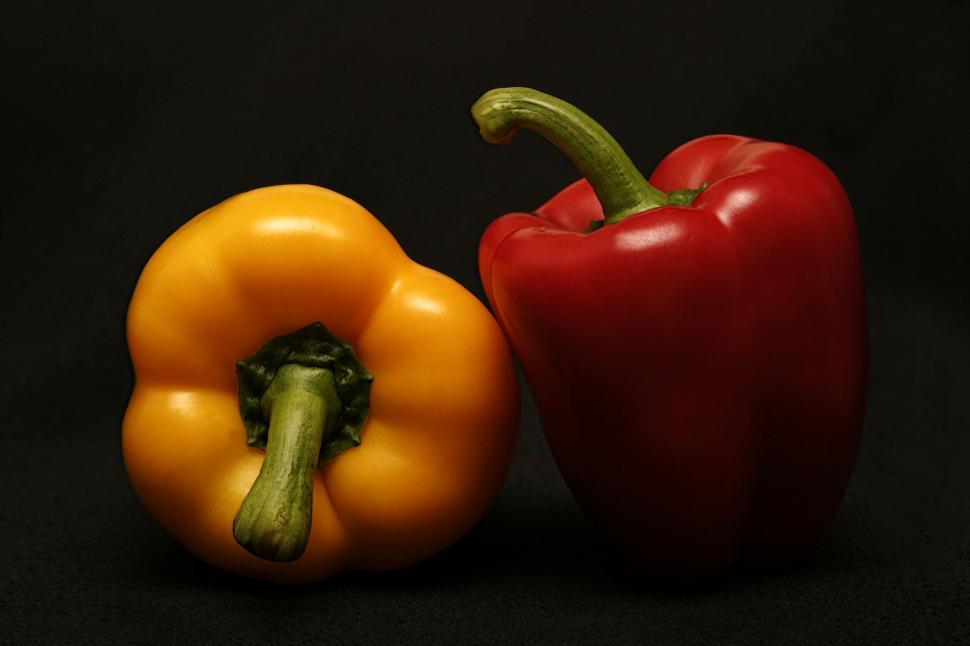 Free Image of Red Pepper and Yellow Pepper on Black Background 