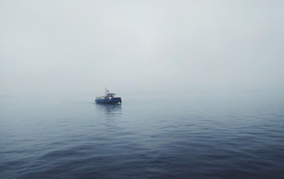 Free Image of Boat Navigating Through Foggy Ocean 