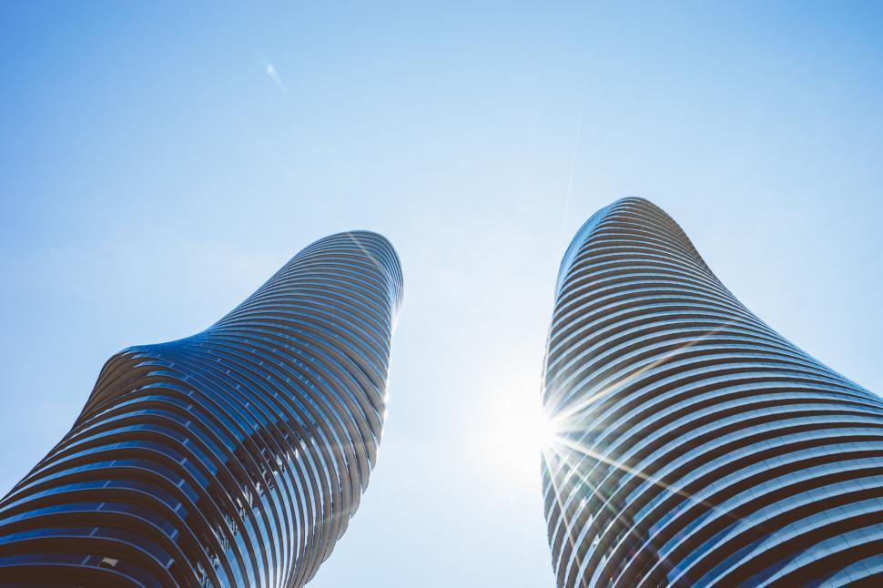 Free Image of Two Tall Buildings Against Bright Blue Sky 