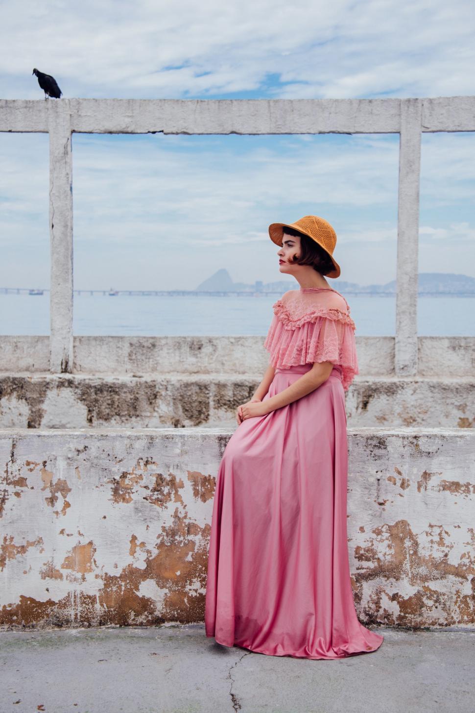 Free Image of Woman Wearing Pink Dress and Hat 