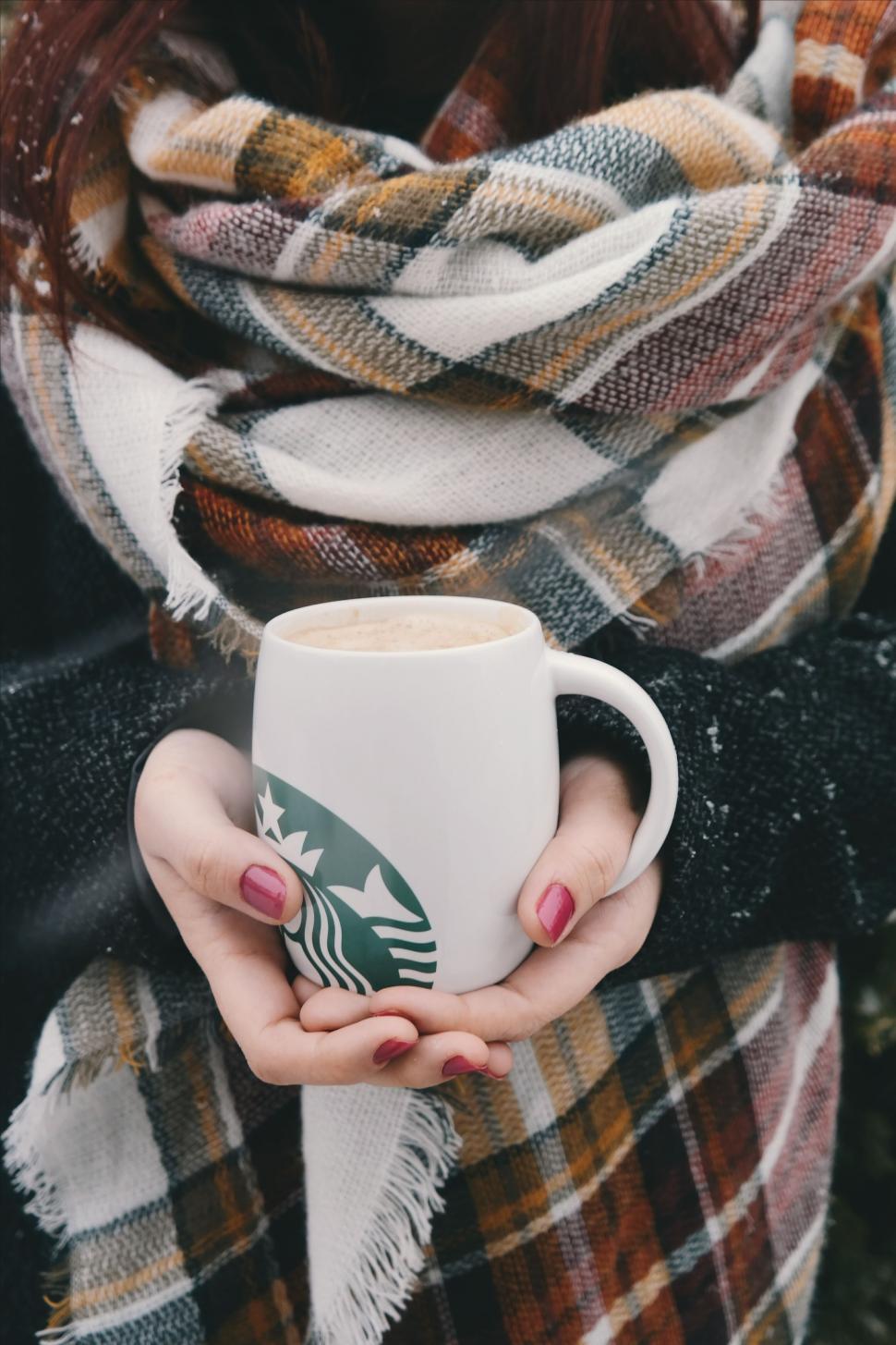 Free Image of Woman Holding Starbucks Coffee Mug 