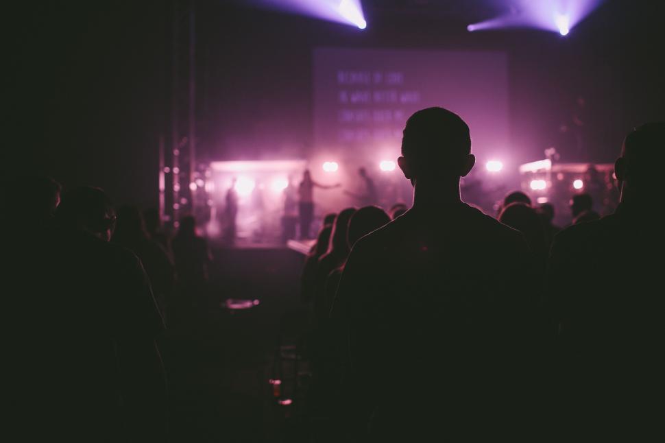 Free Image of Man Standing in Front of Stage at Concert 