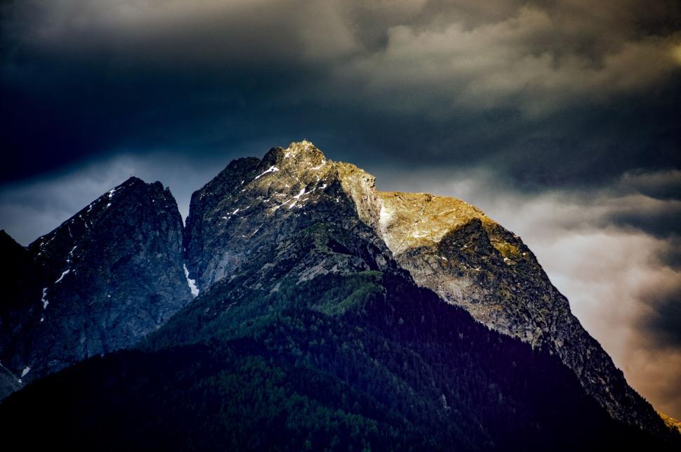 Free Image of Majestic Mountain Towering Under Cloudy Sky 