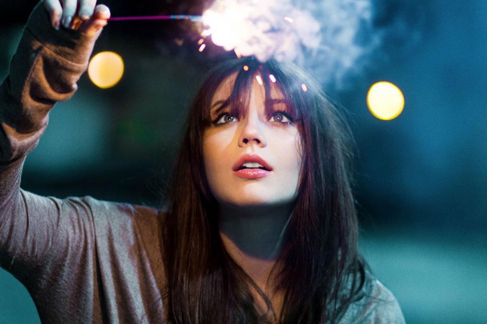 Free Image of Woman Holding a Sparkler in Hand 