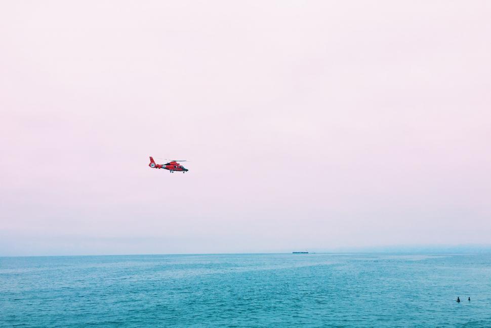 Free Image of Helicopter Flying Over Body of Water 