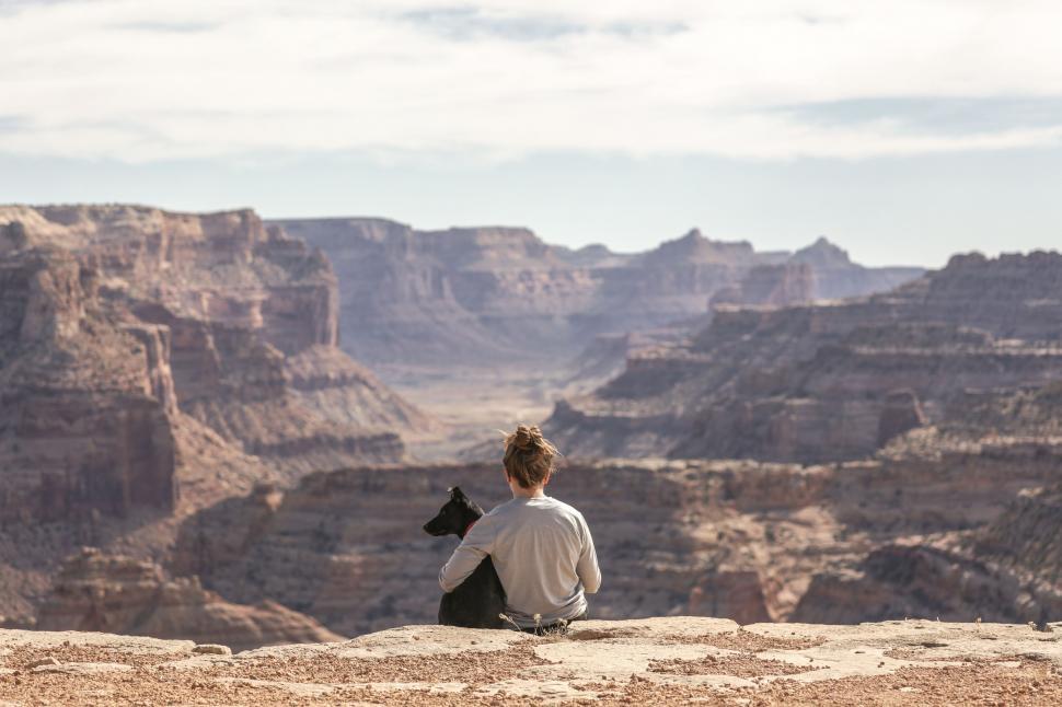 Free Image of Man Sitting on Cliff Overlooking Canyon 