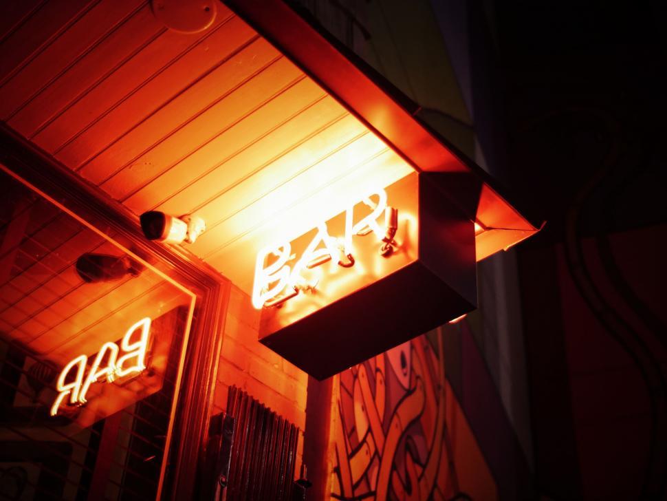 Free Image of Brightly Lit Bar Sign in the Dark 