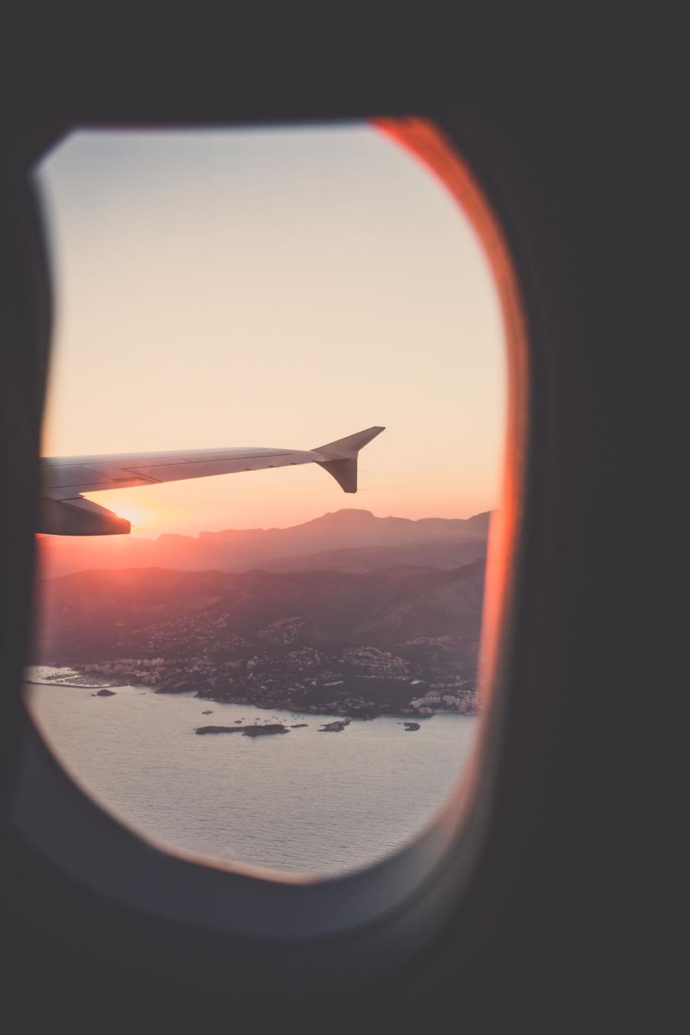 Free Image of Airplane Window View of Body of Water 