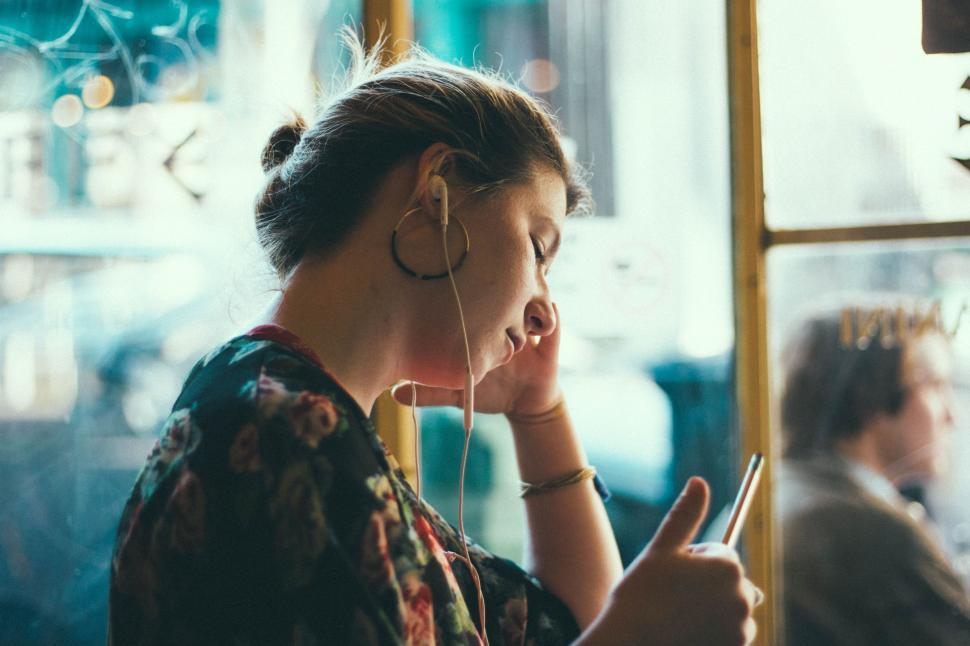 Free Image of Woman Sitting on Bus Using Cell Phone 