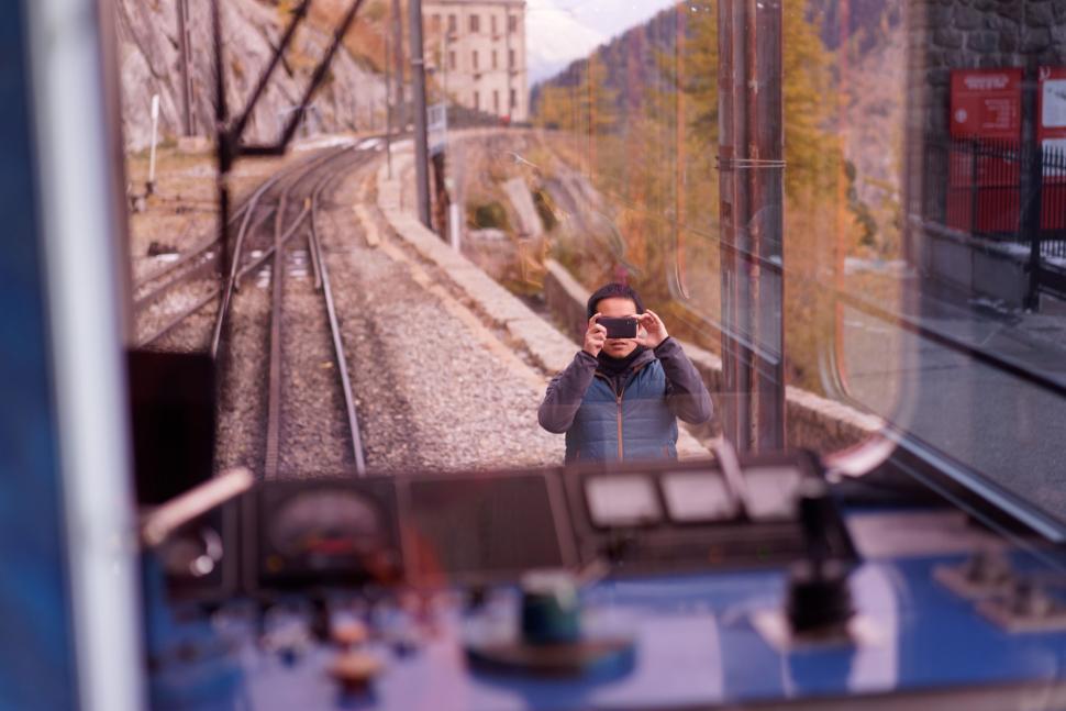 Free Image of Man Taking Picture of Train 