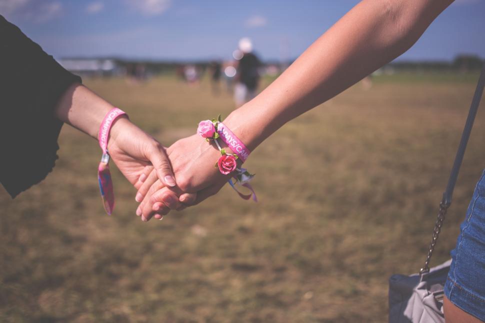 Free Image of Two People Holding Hands in Field 
