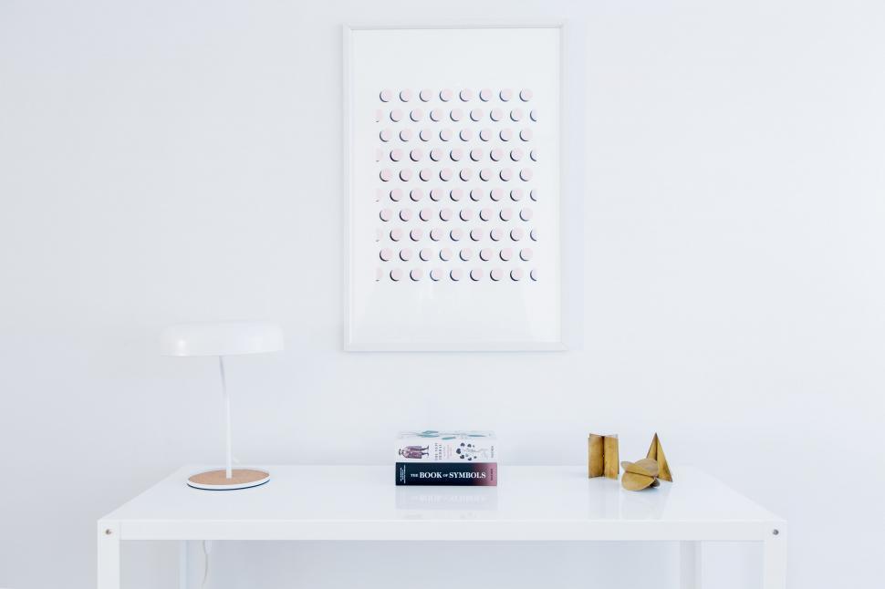 Free Image of White Table With Lamp and Picture on Wall 