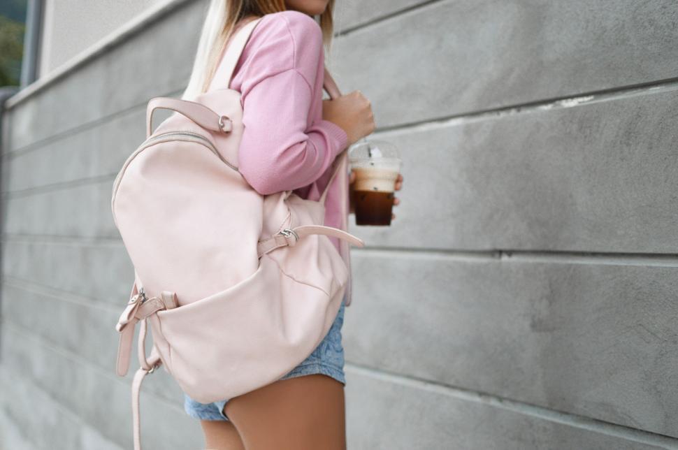 Free Image of Woman With Backpack and Coffee Cup 