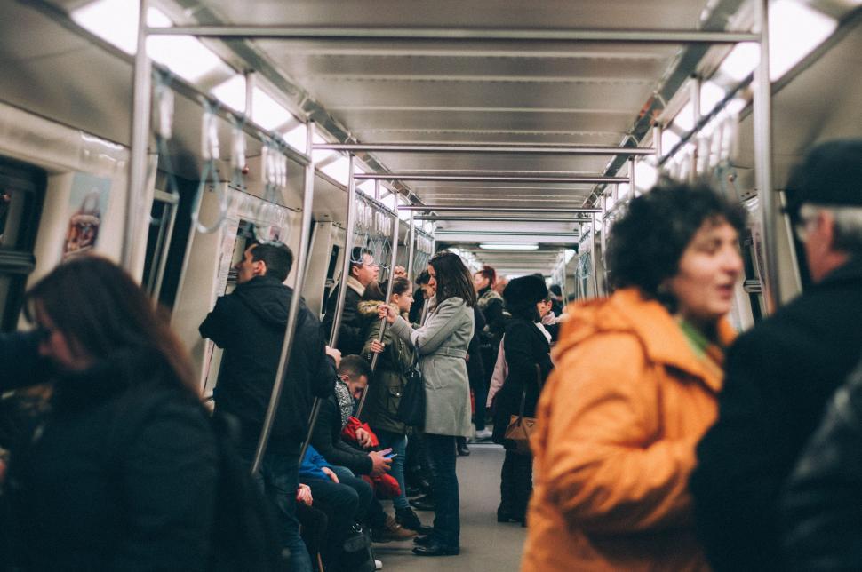 Free Image of Group of People Standing on a Subway Train 
